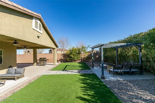 view of yard featuring a patio area, a fenced backyard, a pergola, and a ceiling fan