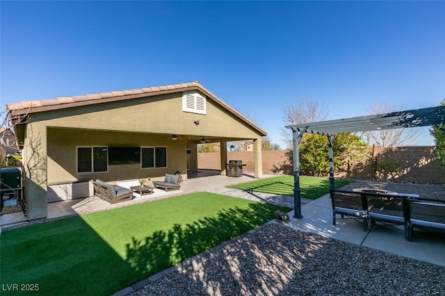 rear view of house with an outdoor living space, ceiling fan, fence, stucco siding, and a patio area