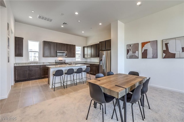 dining room with recessed lighting, visible vents, and light colored carpet