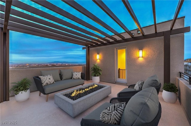 view of patio featuring an outdoor living space with a fire pit and a pergola