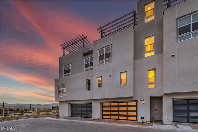 property at dusk with a mountain view