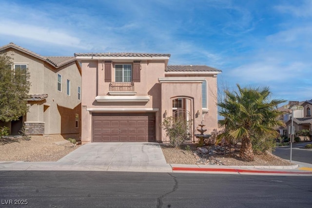 mediterranean / spanish-style home with stucco siding, driveway, a tile roof, and a garage