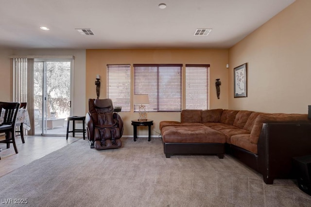 carpeted living room featuring recessed lighting, visible vents, and baseboards