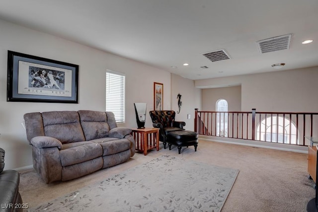 living area with visible vents, carpet floors, and plenty of natural light