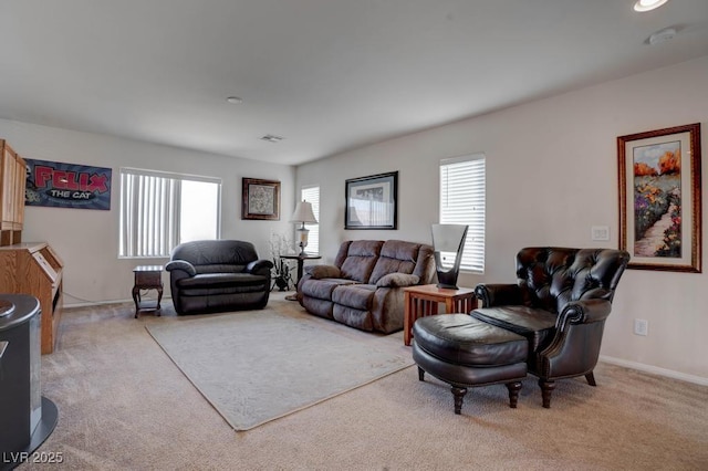 carpeted living area with plenty of natural light, visible vents, and baseboards
