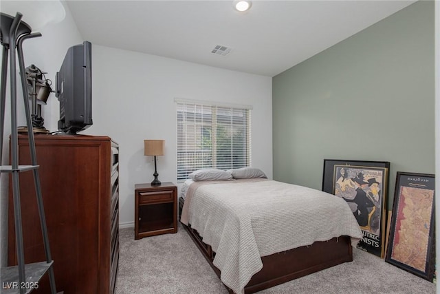 bedroom with visible vents and light carpet