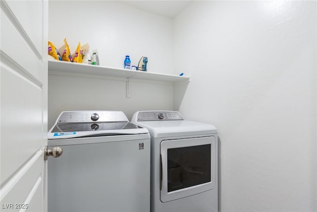 laundry room with washer and clothes dryer and laundry area