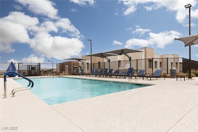 community pool with a residential view, a patio, and fence