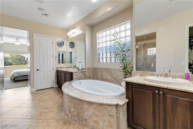 full bathroom featuring a garden tub, visible vents, a shower stall, and a sink