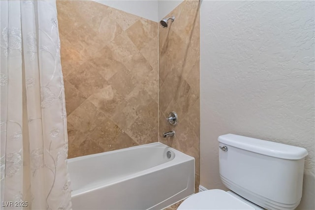 full bath featuring toilet, shower / tub combo, and a textured wall