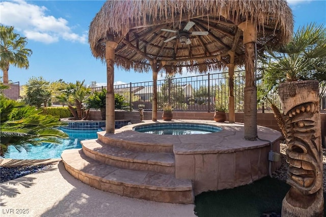 view of pool featuring a gazebo, an in ground hot tub, and fence