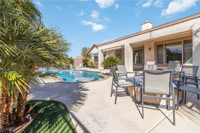 view of swimming pool featuring outdoor dining space, a patio area, and a fenced in pool