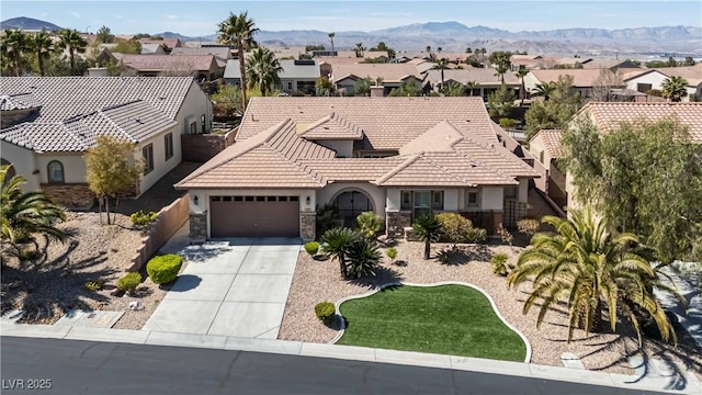 view of front of property with a residential view, stucco siding, driveway, and a garage