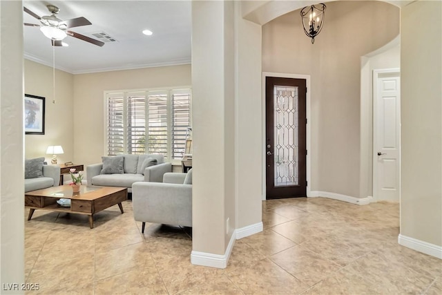 foyer entrance featuring light tile patterned floors, baseboards, visible vents, crown molding, and ceiling fan with notable chandelier