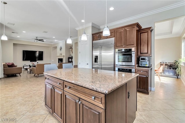 kitchen featuring light tile patterned floors, stainless steel appliances, a kitchen island, and crown molding