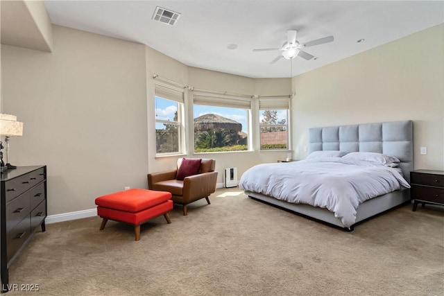 bedroom with visible vents, carpet floors, baseboards, and a ceiling fan