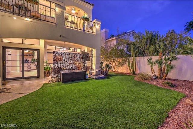 view of yard with a patio, a balcony, and fence