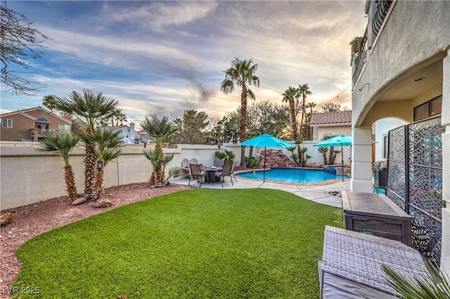 view of yard with a fenced backyard, a fenced in pool, and a patio