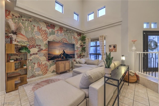 living room featuring tile patterned floors and a towering ceiling