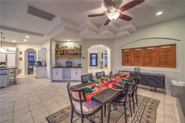 dining space with recessed lighting, light tile patterned floors, visible vents, and arched walkways