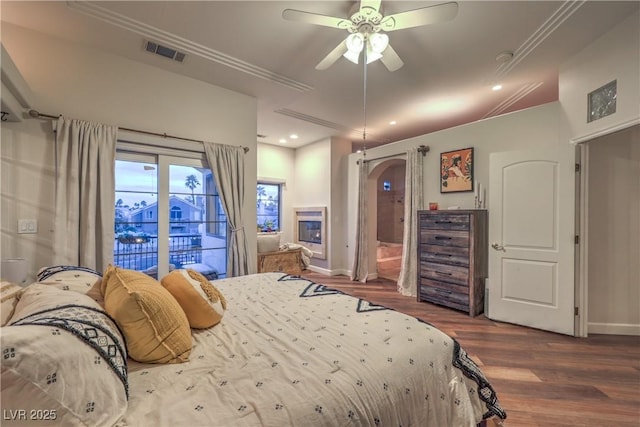 bedroom featuring crown molding, baseboards, visible vents, and dark wood-style flooring