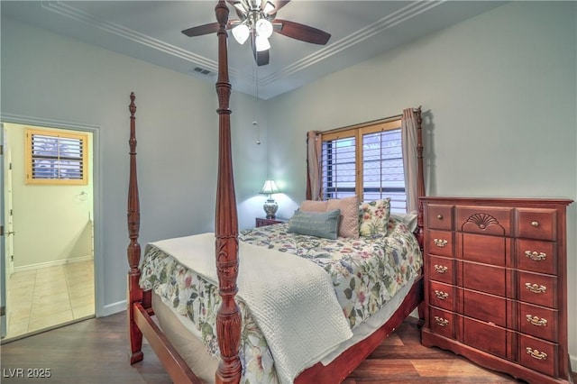 bedroom with ceiling fan, baseboards, wood finished floors, and ornamental molding