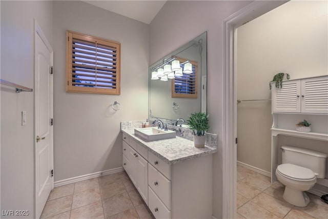 bathroom featuring tile patterned floors, toilet, vanity, and baseboards