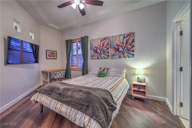 bedroom with crown molding, wood finished floors, baseboards, and ceiling fan