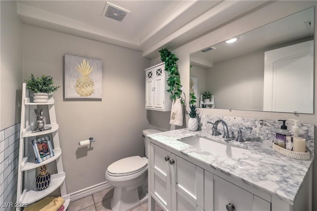 bathroom featuring tile patterned floors, visible vents, toilet, and vanity