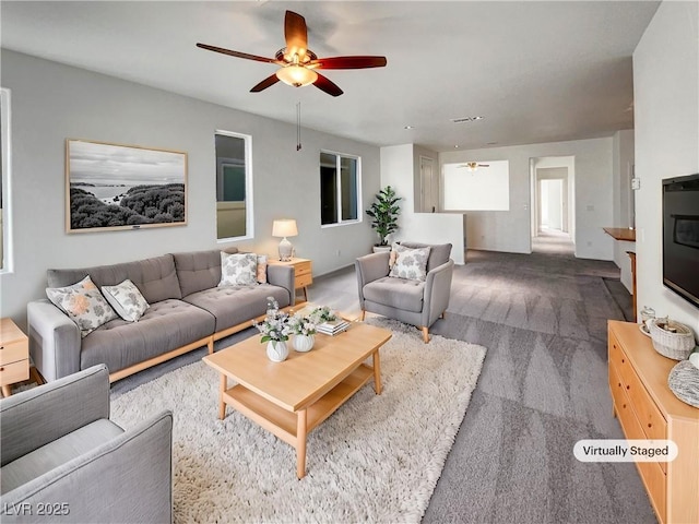 carpeted living room featuring a ceiling fan