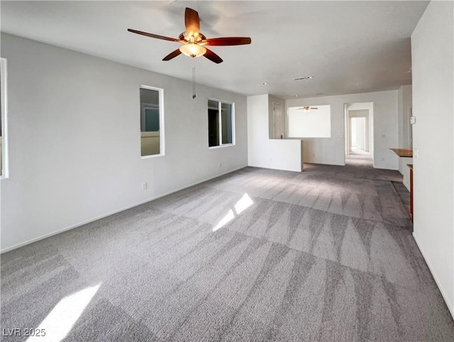 unfurnished living room featuring carpet floors and ceiling fan