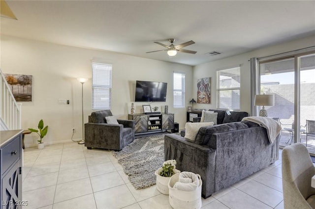 living room with visible vents, baseboards, light tile patterned flooring, and a ceiling fan