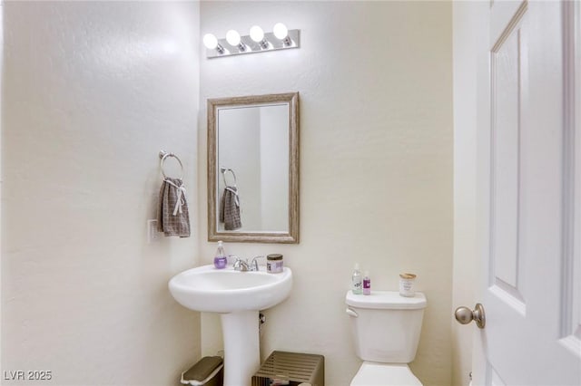 bathroom with toilet and a sink