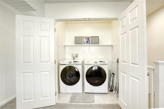 laundry area with tile patterned flooring, visible vents, laundry area, and separate washer and dryer