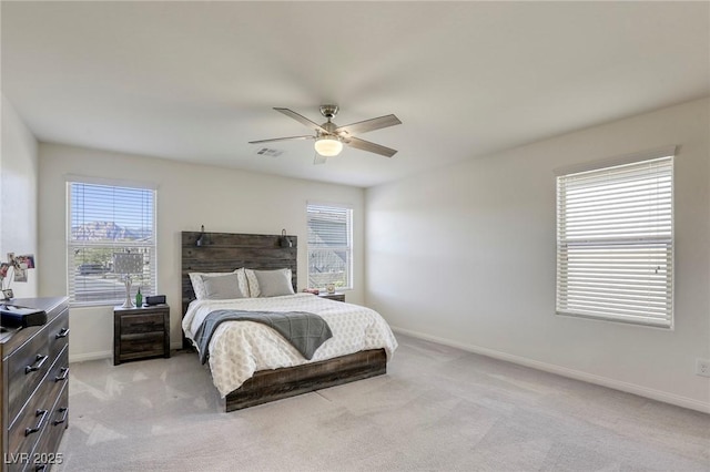 bedroom featuring ceiling fan, baseboards, visible vents, and light carpet