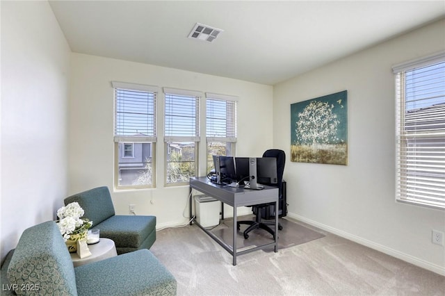 office space with visible vents, plenty of natural light, and carpet floors