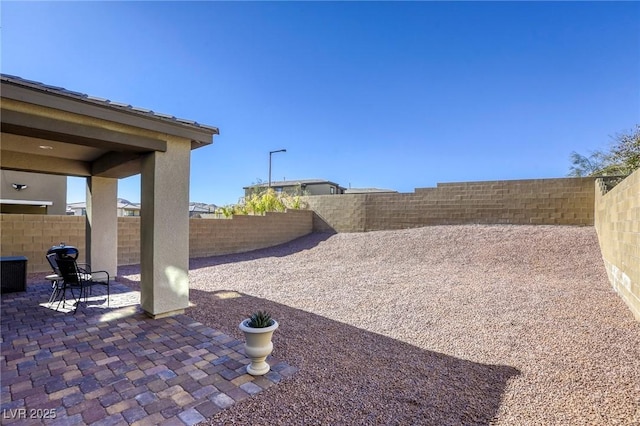 view of yard with a fenced backyard and a patio area