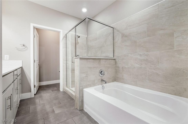 full bathroom with vanity, baseboards, tile patterned flooring, a shower stall, and a bath