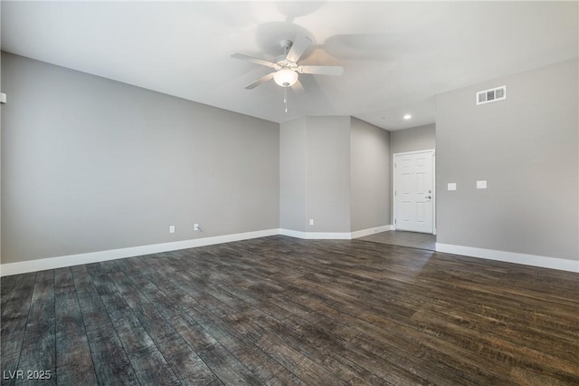 empty room featuring dark wood finished floors, visible vents, a ceiling fan, and baseboards