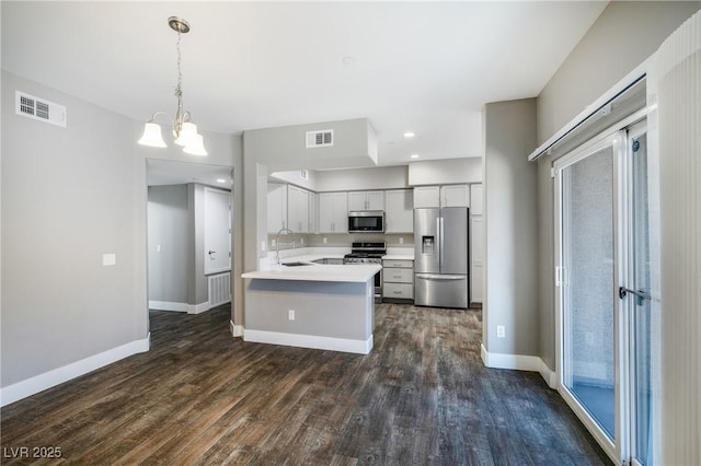 kitchen featuring visible vents, appliances with stainless steel finishes, dark wood-style flooring, and light countertops