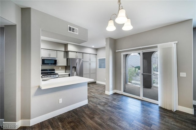 kitchen featuring dark wood-style floors, visible vents, baseboards, light countertops, and appliances with stainless steel finishes