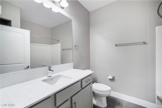 bathroom featuring tile patterned flooring, toilet, vanity, and baseboards