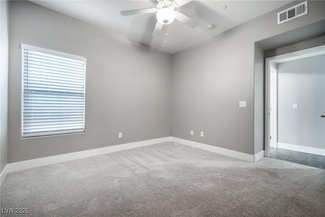 unfurnished room featuring a ceiling fan, visible vents, carpet floors, and baseboards