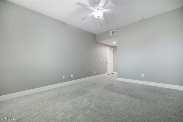 spare room featuring carpet flooring, a ceiling fan, visible vents, and baseboards