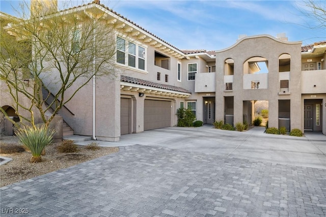 11890 Tevare Ln Unit 1098, Las Vegas, NV 89138 - view of front of home with stucco siding, an attached garage, driveway, and a tile roof
