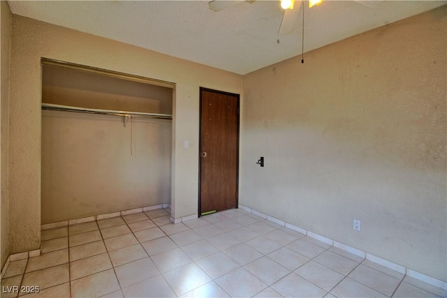 unfurnished bedroom featuring light tile patterned flooring and ceiling fan