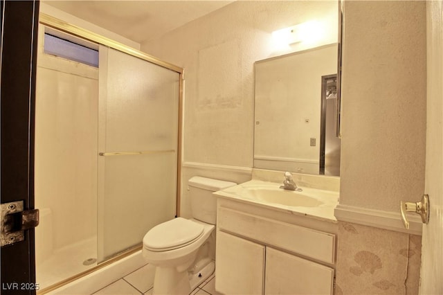 full bath with tile patterned flooring, a stall shower, toilet, and vanity