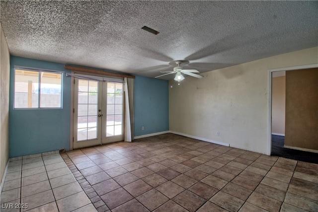 unfurnished room with tile patterned flooring, french doors, a textured ceiling, and a ceiling fan