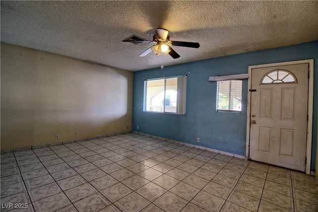 entrance foyer featuring a textured ceiling and ceiling fan