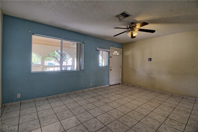 interior space with visible vents, a textured ceiling, and ceiling fan